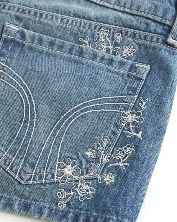 Ultra Low-Rise Medium Wash Floral Embroidered Denim Mini Shorts Ultra Low-Rise Medium Wash Floral Embroidered Denim Mini Shorts