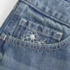 Ultra Low-Rise Medium Wash Floral Embroidered Denim Mini Shorts Ultra Low-Rise Medium Wash Floral Embroidered Denim Mini Shorts